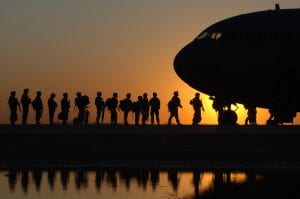 soldiers boarding aircraft in a line