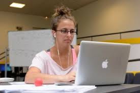 Female student watches a video on her laptop