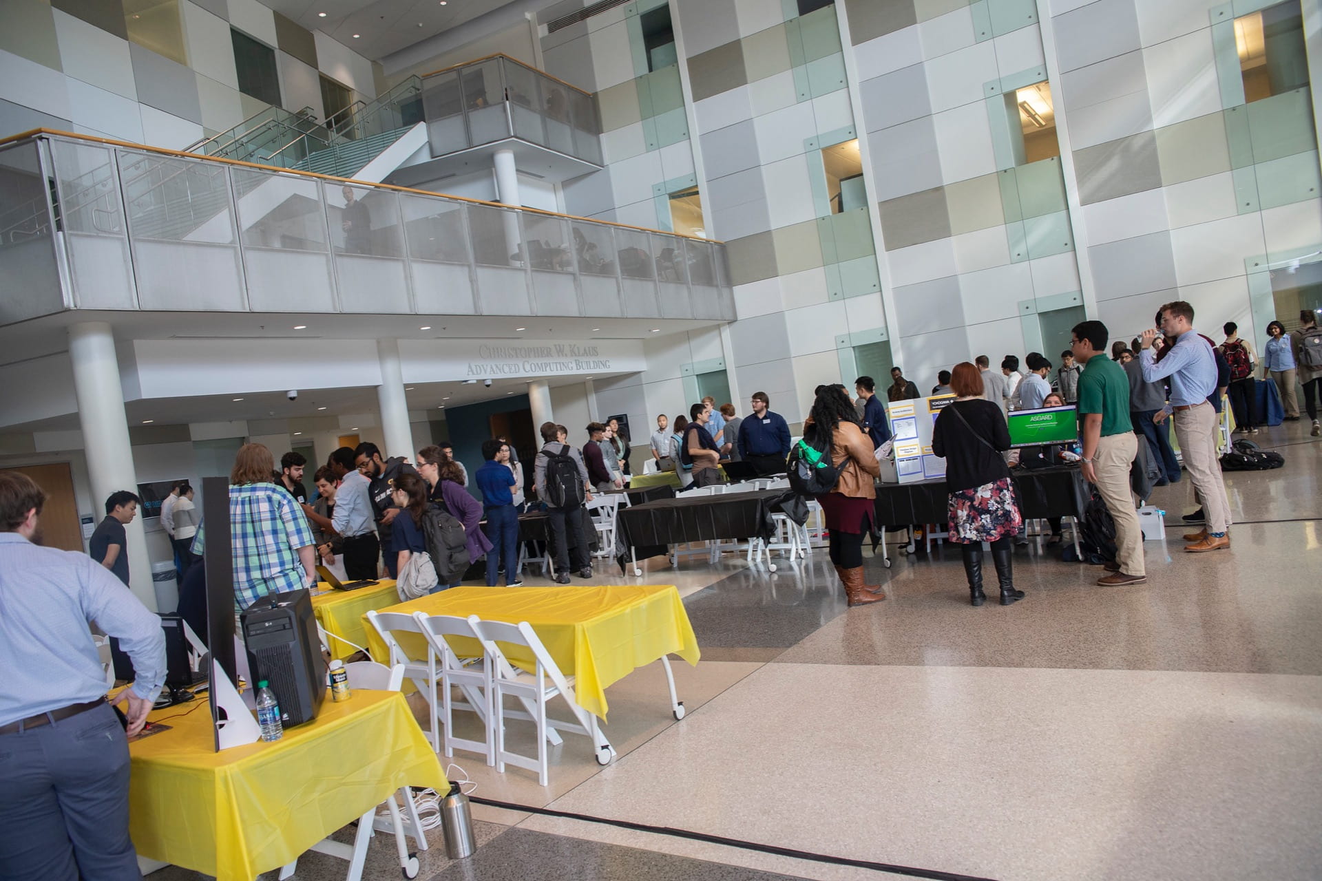 The Klaus Atrium is filled with people at a student capstone expo 